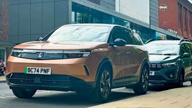 Vauxhall Grandland Electric GS long-term - front 3/4 with a Dacia